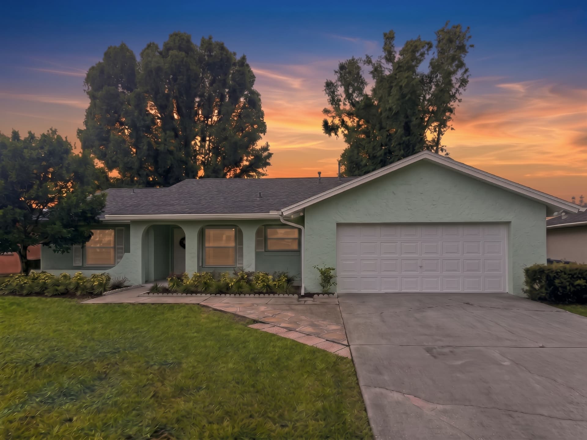 Front of 2658 Ceram Avenue at sunset with two-car garage
